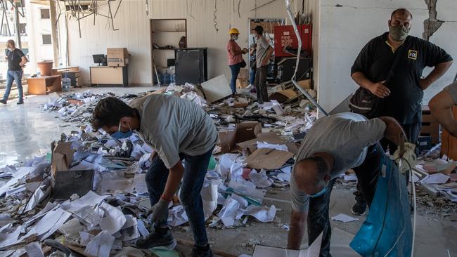 Employees clear rubble inside the destroyed Lebanon Electricity Company (EDL) building in Beirut. Picture: Getty Images.