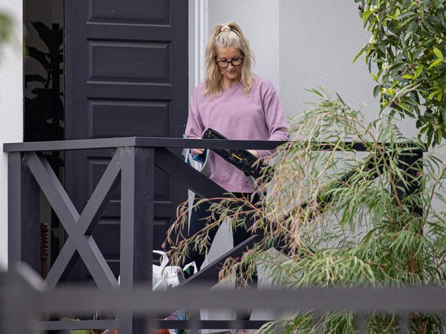 Cleaners attend the Airbnb where Jamie Kah was found with fellow jockeys.