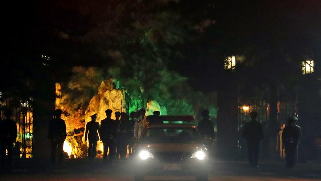 A military honor guard is seen marching away after a convoy of vehicles enter the Diaoyutai State Guesthouse. Picture: Ng Han Guan/AP