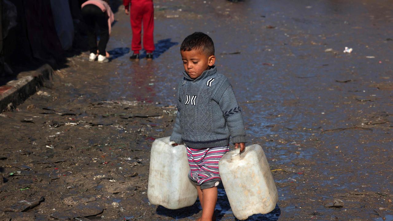 A young boy carries empty jerry cans in Rafah in the southern Gaza Strip. Picture: AFP