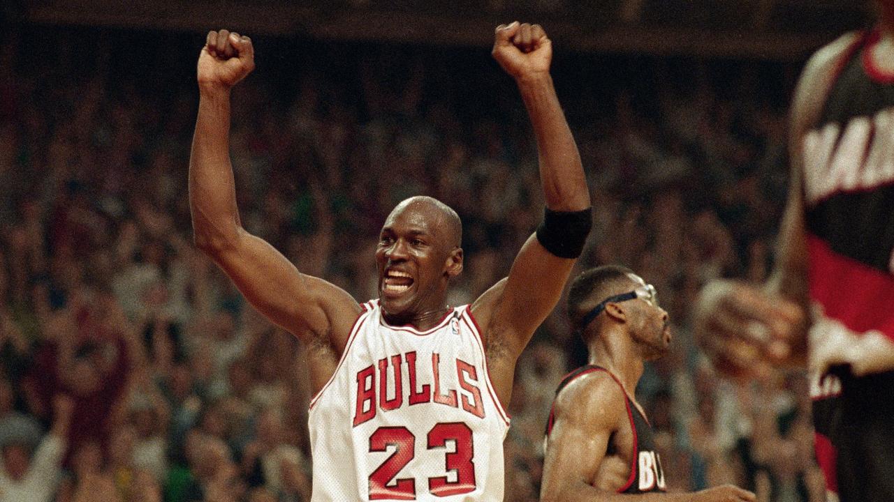 Michael Jordan celebrates the Bulls win over the Portland Trail Blazers in the NBA Finals in Chicago. (AP Photo/John Swart, File)