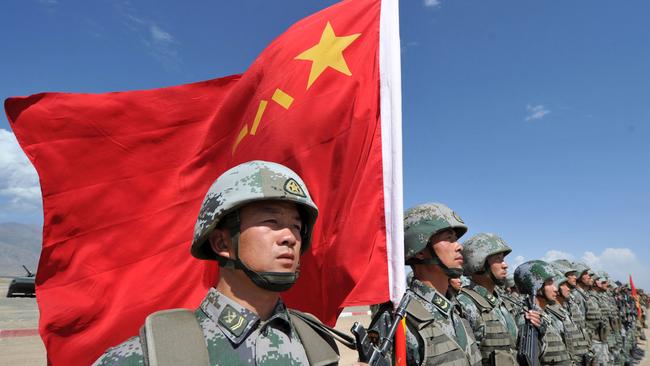 A soldier holds a Chinese flag during joint military exercises of the Shanghai Co-operation Organisation in Kyrgyzstan in 2016. Picture: AFP