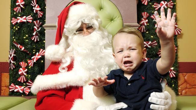 An upset Jack Gordon, 1, sits on Santa's knee. Picture: Claudia Baxter