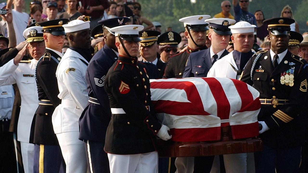 A US military honor guard carries the casket of former US President Ronald Reagan to a horse drawn caisson in front of the White House in 2004. Picture: AFP/Stan Honda