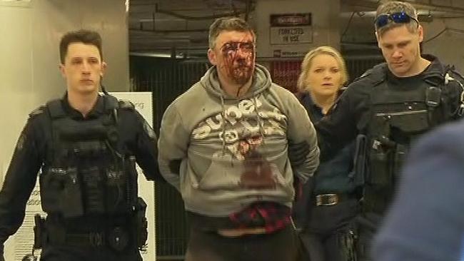 Jonathan Dick is arrested in a parking garage next to Hosier Lane in Melbourne’s CBD. Credit: 7 News