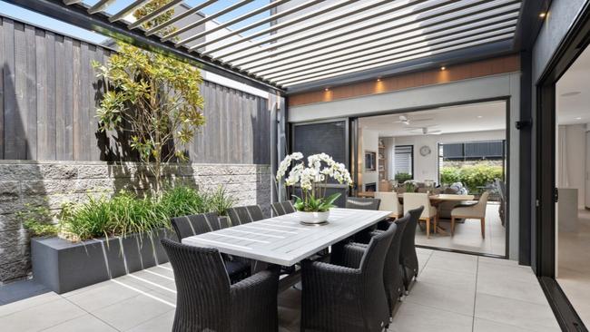 The two-storey, 2022-built townhouse has a roofed alfresco courtyard. Picture: realestate.com.au