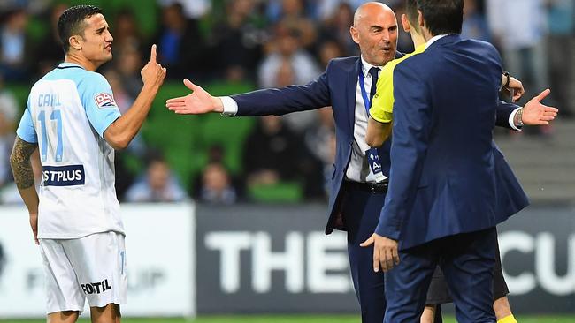 Tim Cahill and Kevin Muscat clash during the first half of the Melbourne Derby. Pictue: Getty Images