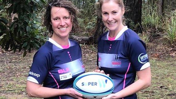 CFA people and culture executive director Liz Radcliffe (left) with CFA deputy chief officer Steph Rotarangi in rugby gear.