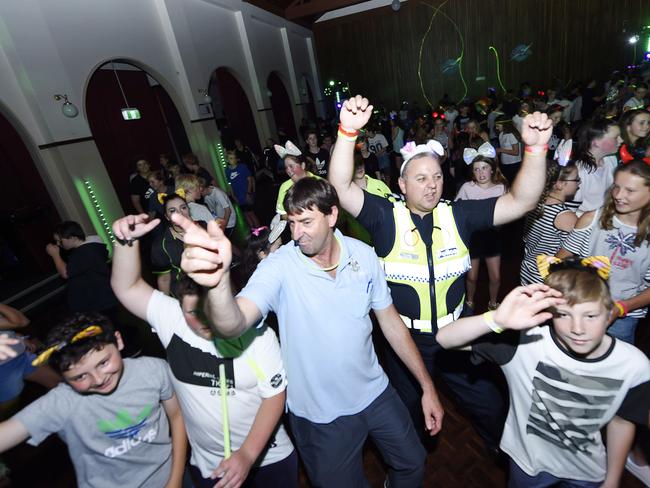 Leading Senior Constable Andy Brittain, centre, busting some moves at the blue light disco at Geelong West Town Hall. Picture: Alan Barber