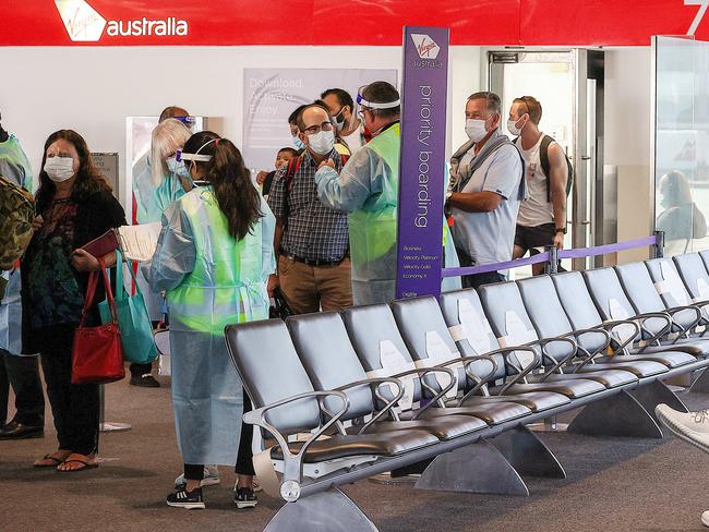 Covid-19 Enforcement and Compliance Officers  check documentation of returning travellers from Brisbane in the Virgin terminal at Melbourne Airport. Brisbane is currently in a 3 day lockdown due to a Covid-19 cluster. Picture : Ian Currie