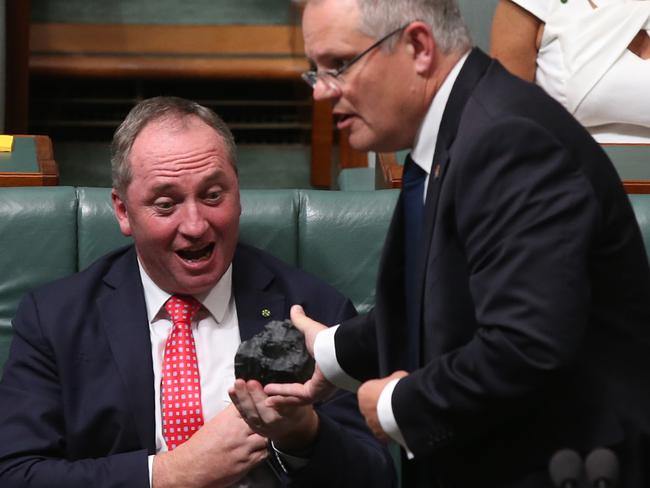 Treasurer Scott Morrison hands Deputy PM Barnaby Joyce a piece of coal during Question Time in the House of Representatives Chamber at Parliament House in Canberra. Picture: Kym Smith