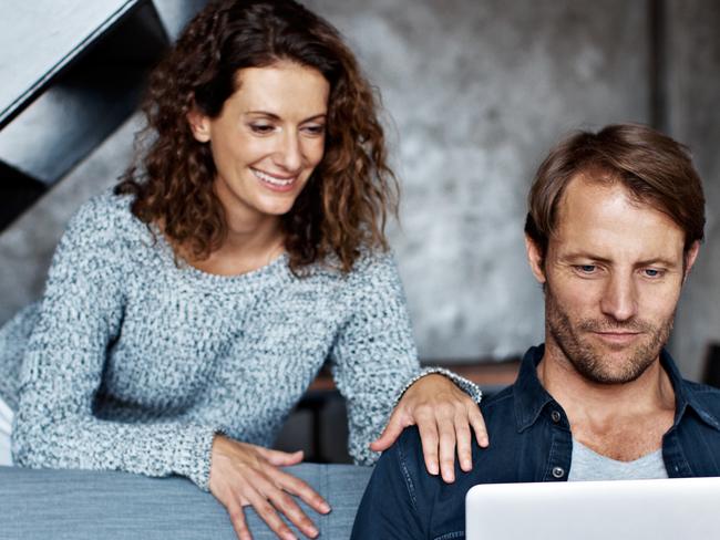 Shot of a mature couple using a laptop in their living room