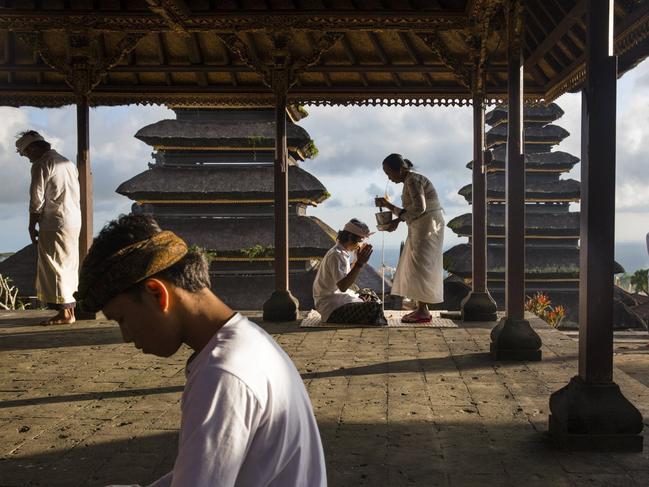 Blessings at Besakih Besakih Temple has been known as Bali Mother Temple for over 1000 years and is perched 1000 metres high on the southwestern slopes of Mount Agung. Here Balinese often come to offer up prayer and take blessing from the temple priests or Pemangku who reside there. Picture: Michael Dean Morgan / National Geographic Travel Photographer of the Year