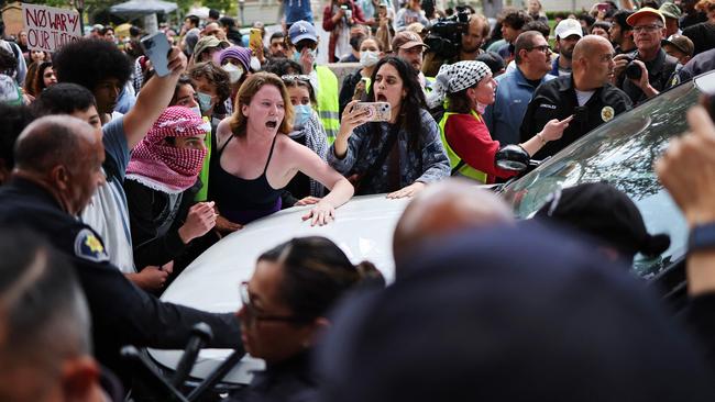 Pro-Palestine demonstrators argue with campus cops after they tried to take down an encampment at the University of Southern California on Wednesday. Picture: AFP