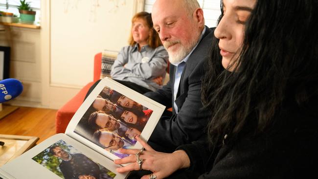 Mikhail and Danielle Gershkovich, father and sister of detained journalist, Evan Gershkovich, with his mother, Ella (left) look at photos of Evan in her wedding album in Danielle's apartment in Philadelphia. Picture: AFP