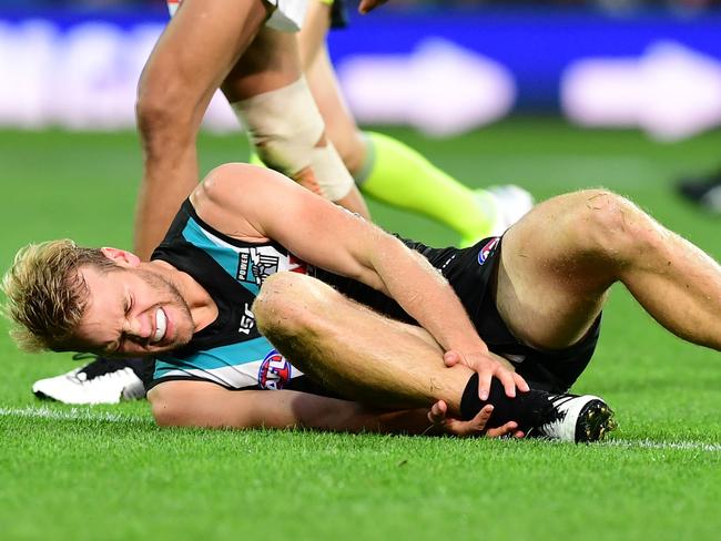 ADELAIDE, AUSTRALIA - MARCH 30: Jack Watts of Port Adelaide hold his ankle after a clash with Dale Thomas of the Blues during the round two AFL match between the Port Adelaide Power and the Carlton Blues at Adelaide Oval on March 30, 2019 in Adelaide, Australia. (Photo by Mark Brake/Getty Images)