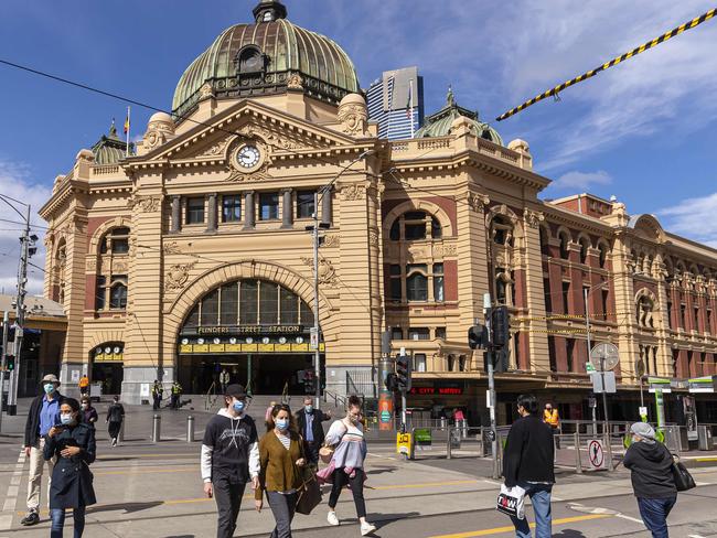 MELBOURNE, AUSTRALIA - NewsWire Photos October 01, 2021:  People are seen crossing Flinders Street in Melbourne, Victoria. Picture: NCA NewsWire / Daniel Pockett