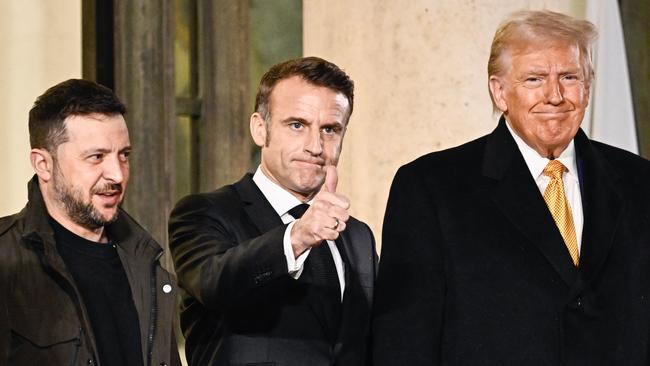 Mr Trump with France's President Emmanuel Macron (C) and Ukraine's President Volodymyr Zelensky. Picture: AFP