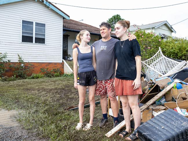 Corey Saunders, with kids Tahlia and Brianna, at their Taree home he cannot afford to insure. Picture: Thomas Lisson