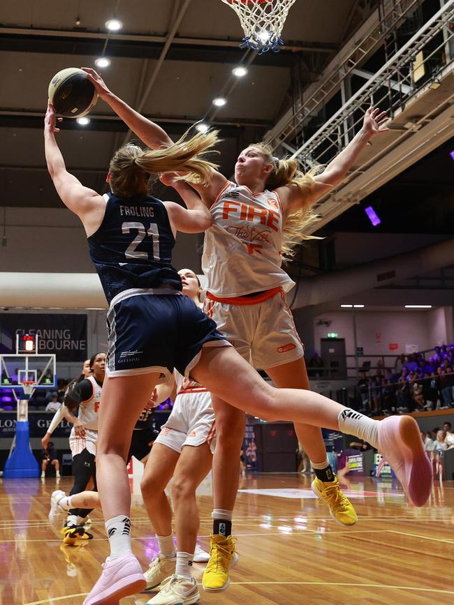 GEELONG, AUSTRALIA - OCTOBER 30: Keely Froling of Geelong United is blocked by Lauren Cox of the Townsville Fire during the round one WNBL match between Geelong United and Townsville Fire at The Geelong Arena, on October 30, 2024, in Geelong, Australia. (Photo by Kelly Defina/Getty Images)