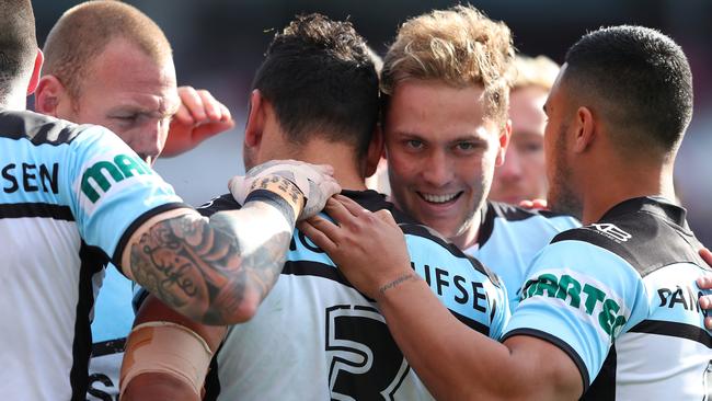 Matt Moylan and his Sharks teammates celebrate a try against the Knights.