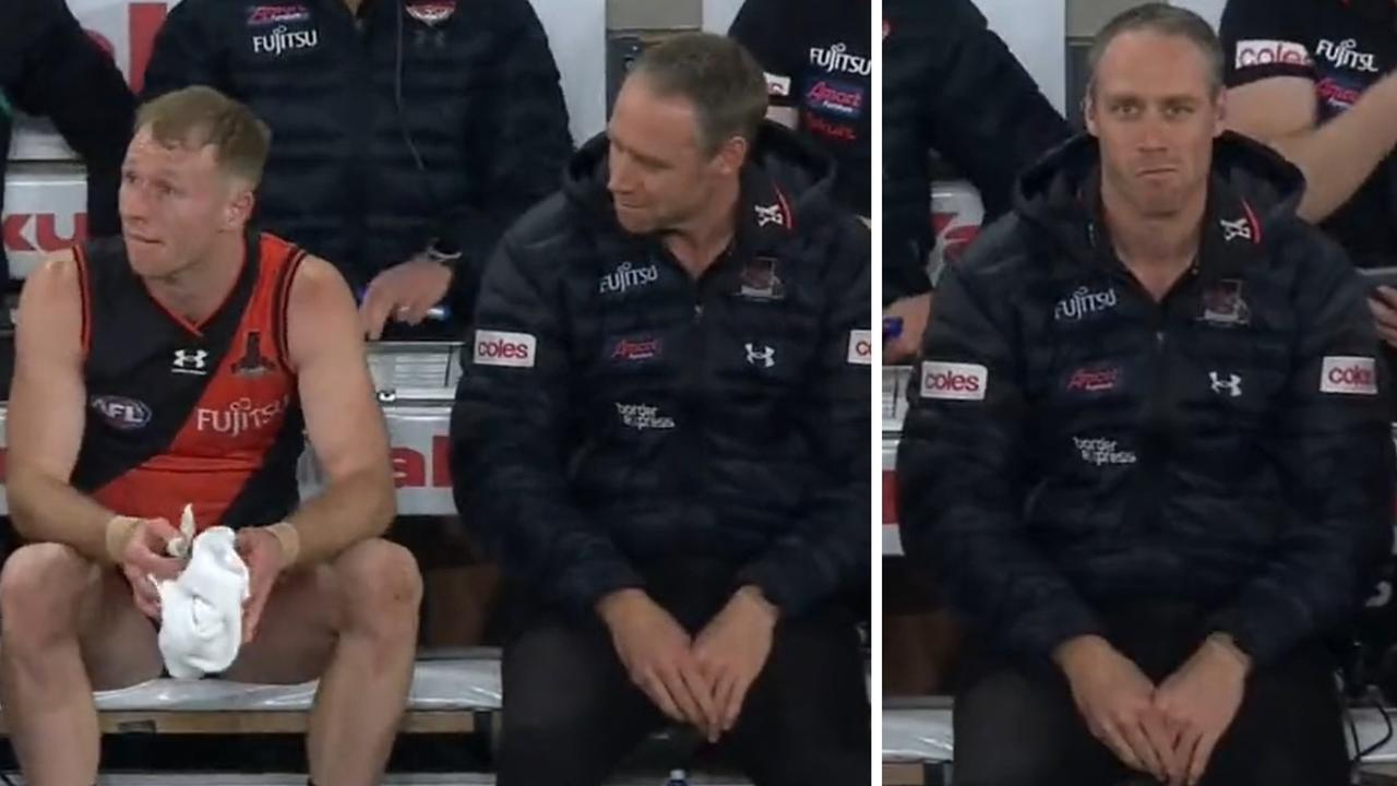 Nick Hind appears to ignore Ben Rutten on the bench during Essendon's win over North Melbourne.