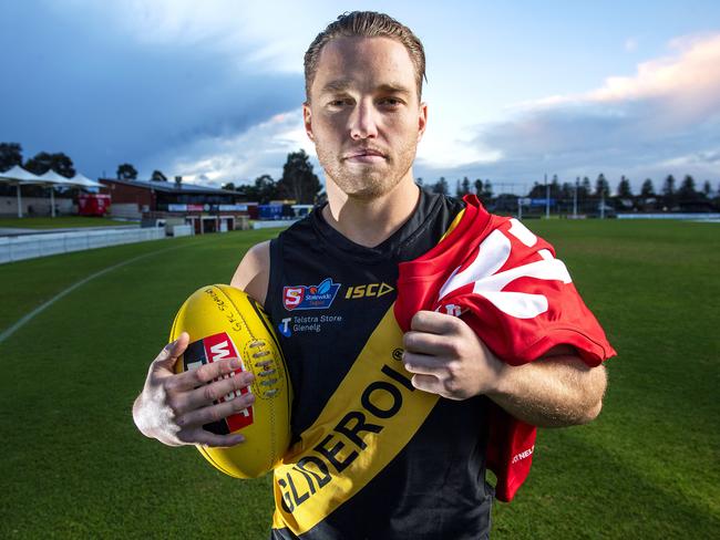 Glenelg footballer Michael Virgin holding a North Adelaide guernsey in honour of his father North Adelaide president Lee Virgin who passed away at Glenelg Oval ACH Group Stadium Tuesday, June,8,2021.Picture Mark Brake