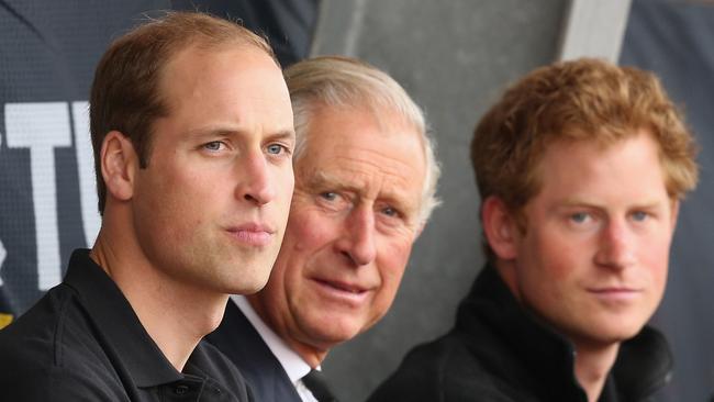 Prince William, Duke of Cambridge, Prince Harry and Prince Charles, Prince of Wales watch the athletics at Lee Valley Track during the Invictus Games in 2014 in London.