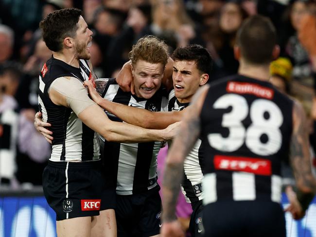 MELBOURNE, AUSTRALIA - AUGUST 17: (L-R) Jack Crisp, Beau McCreery and Nick Daicos of the Magpies celebrate during the 2024 AFL Round 23 match between the Collingwood Magpies and the Brisbane Lions at The Melbourne Cricket Ground on August 17, 2024 in Melbourne, Australia. (Photo by Michael Willson/AFL Photos via Getty Images)