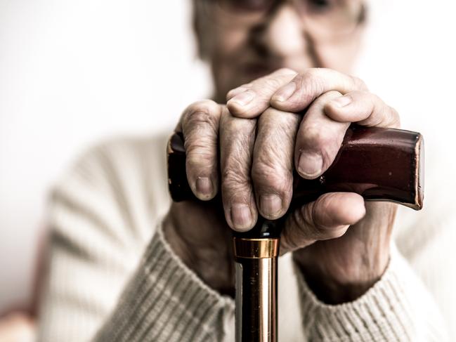 Old woman with cane. Istock