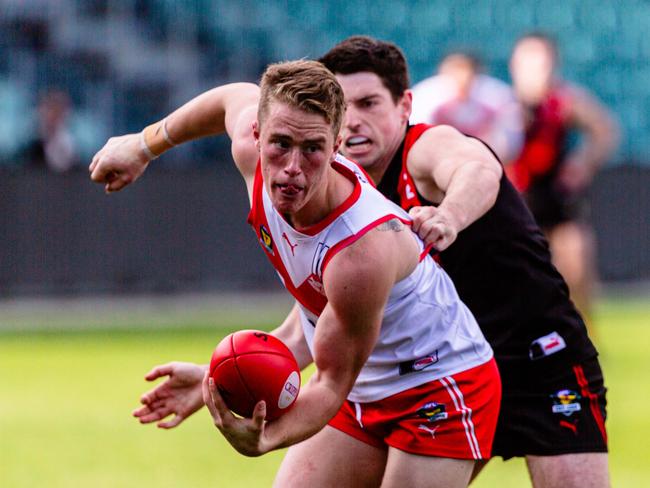 Tasmanian State League Preliminary Final between North Launceston and Clarence. Jack Preshaw of Clarence tries to hand ball while Ben Simpson of North Launceston tackles. Picture: Linda Higginson