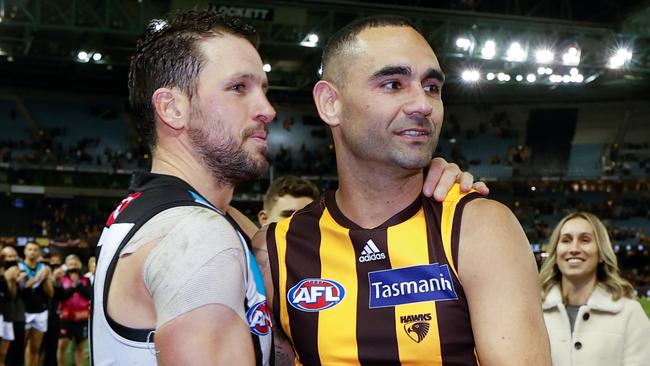 MELBOURNE, AUSTRALIA - JULY 03: Shaun Burgoyne of the Hawks is embraced by Travis Boak of the Power after his 400th match during the 2021 AFL Round 16 match between the Hawthorn Hawks and the Port Adelaide Power at Marvel Stadium on July 3, 2021 in Melbourne, Australia. (Photo by Michael Willson/AFL Photos via Getty Images)