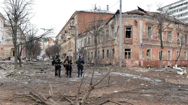 Ukrainian police officers patrol a street following a shelling in Ukraine's second-biggest city of Kharkiv. Picture: AFP