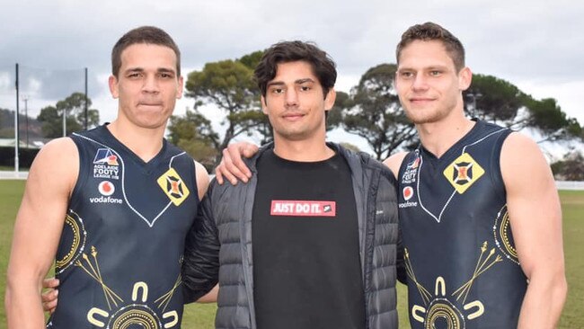 Jy Farrar, right, with Adelaide Crows forward Shane McAdam, centre, and Ash Johnson.