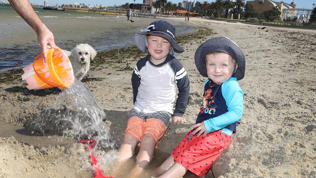 10AM: Noah and Flynn Siegert cool their feet at St Kilda Beach. Picture: David Crosling