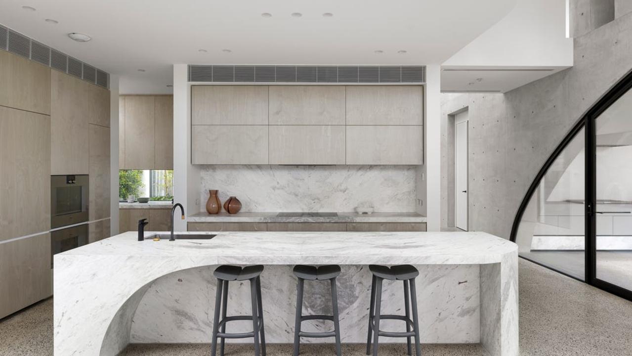 The kitchen is fitted with an island bench and Italian-imported appliances.