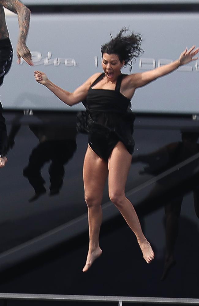 Kourtney Kardashian Travis Barker jump from boat after lavish