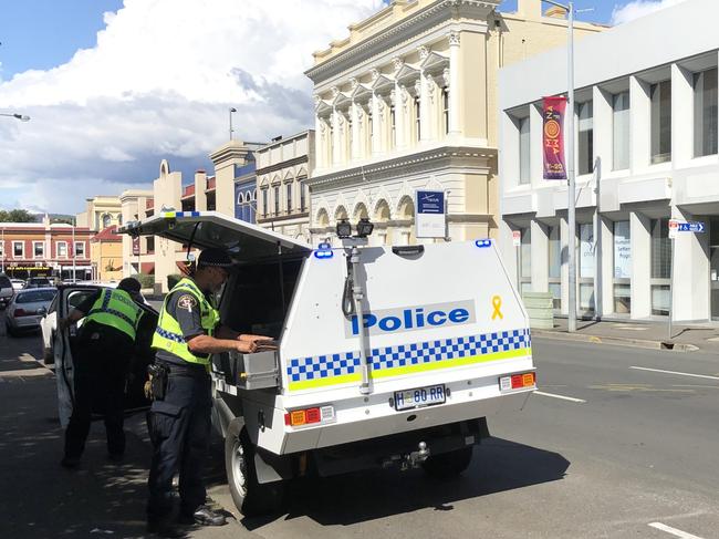 Cleaners at the scene of a fatal car crash involving a police car and pedestrians in Launceston. Picture: PATRICK GEE