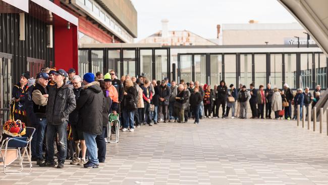 People line up for tickets to the Crows and Port finals matches on Tuesday. Picture: AAP/James Elsby