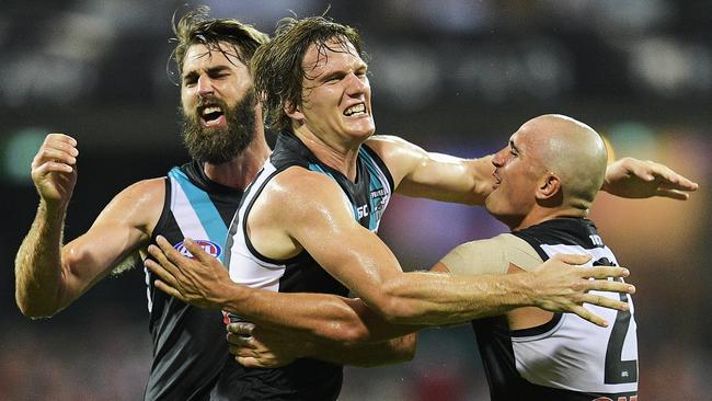 Jared Polec celebrates kicking a goal with Justin Westhoff and Sam Powell-Pepper.