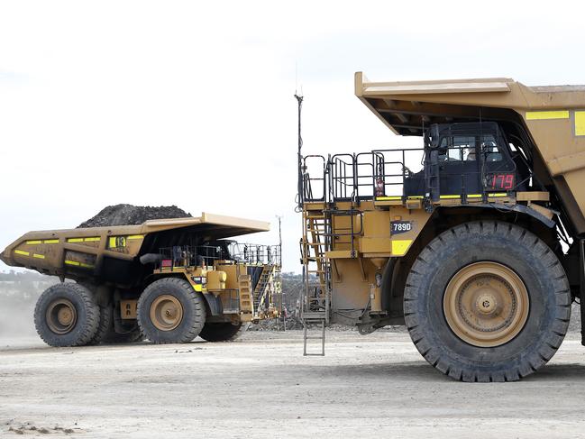 Trucks at the New Acland mine. The industry is looking closely at government plans to bring emissions down. Picture: Josh Woning