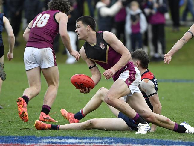 Harry Armstrong gets a handball away while playing for Haileybury last weekend. Picture: Andrew Batsch