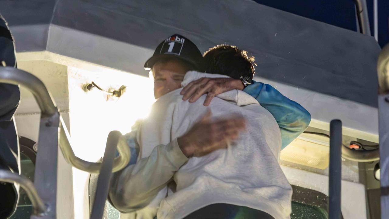 Brett McIntosh hugging his son after arriving back on shore. Picture: NSW Police