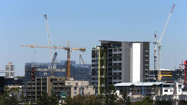 views of cranes building high rise apartment blocks on the South Brisbane skyline .