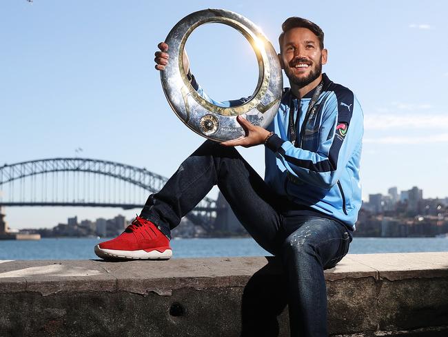 Milos Ninkovic, with his champions medal, poses at Mrs Macqurie’s Chair after announcing his extended contract with Sydney FC. Picture: Brett Costello