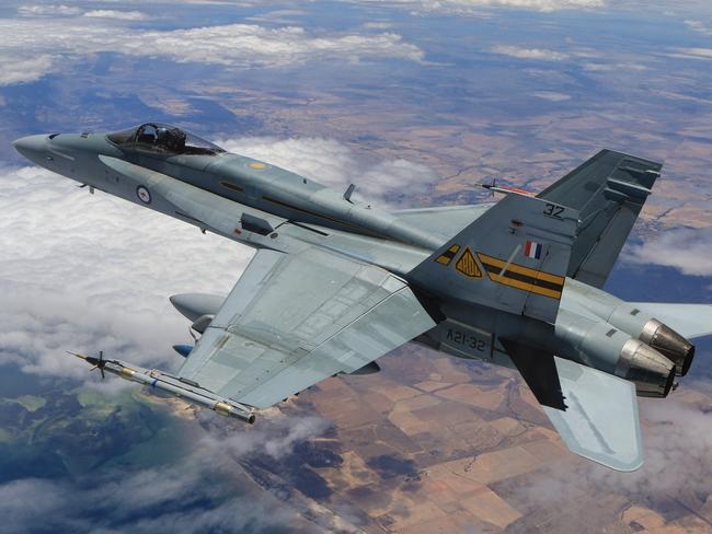 An F/A-18A Hornet carries guided missiles to the Woomera test range.