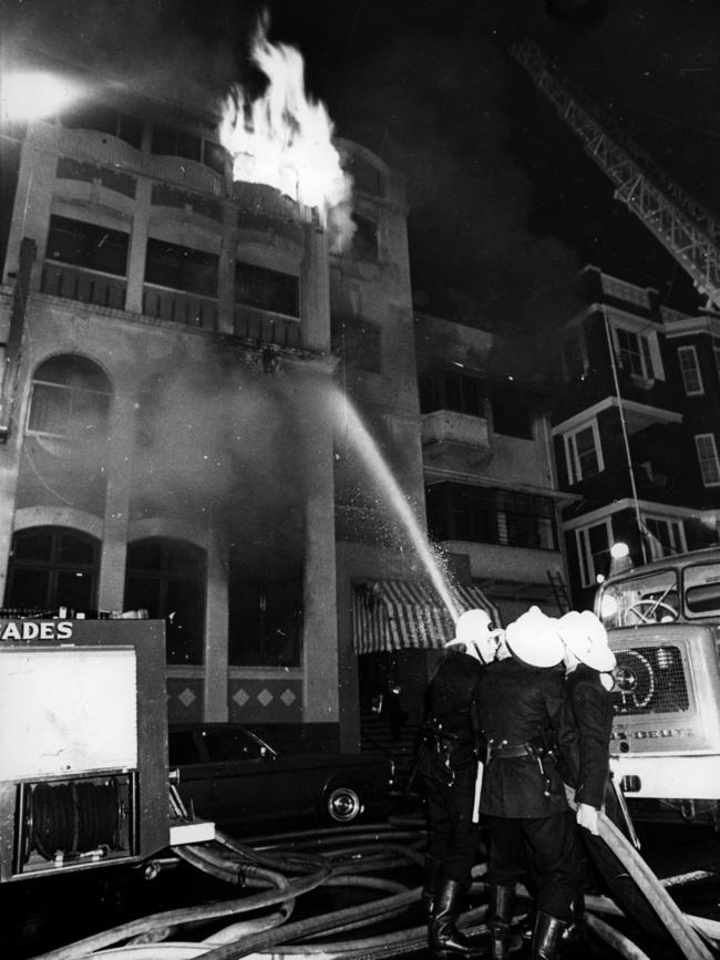 Officers attempt to extinguish the blaze in the Rembrandt Apartments in Kings Cross.