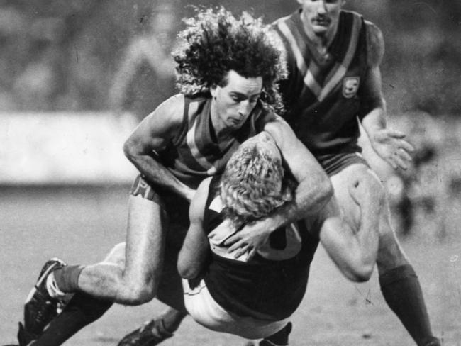 Hawk John Platten (South Australia) tackles club teammate Brereton at Football Park.