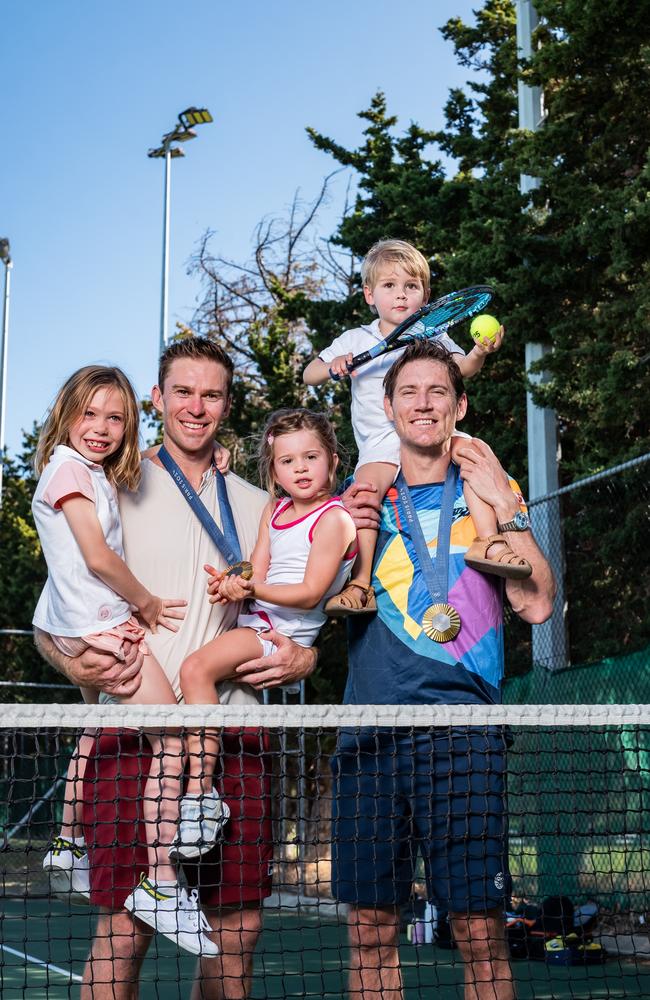 John Peers with his daughters, Ellie and Harper and Matthew Ebden with his son, Harvey. Picture: Tony McDonough