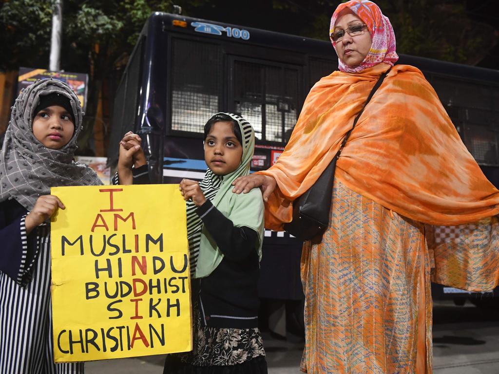 Young demonstrators hold a placard as they form a human chain with adults protesting against India's new citizenship law. Picture: AFP